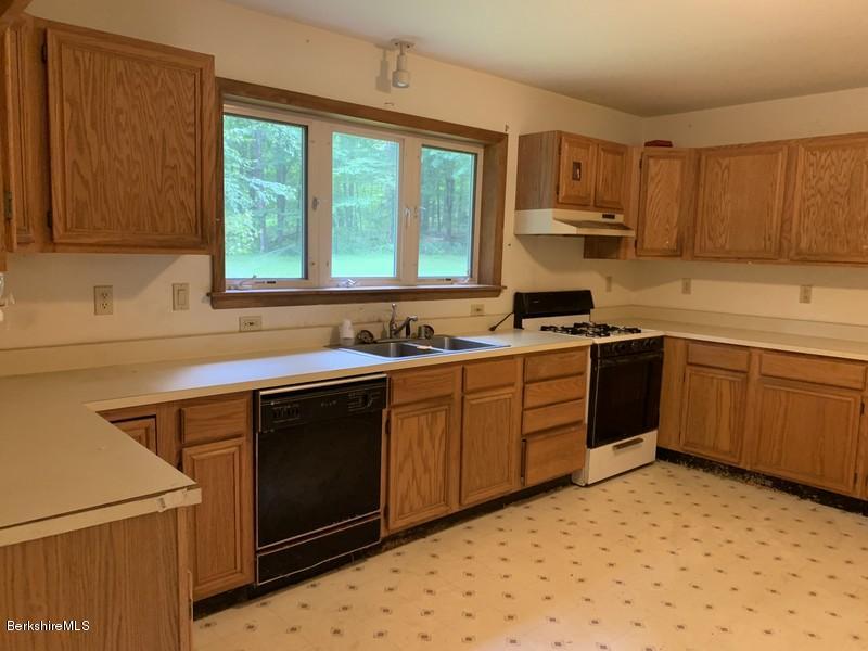 12 Quiet Knoll Road Stockbridge, MA 01266 - Photo 12 of 37 a kitchen with stainless steel appliances granite countertop a sink stove and microwave