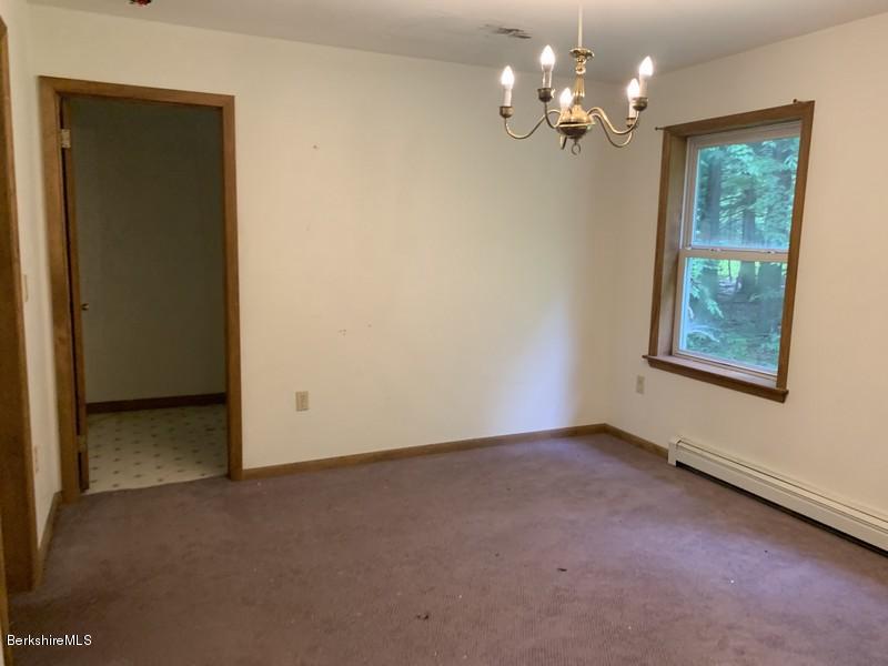 12 Quiet Knoll Road Stockbridge, MA 01266 - Photo 13 of 37 an empty room that has a chandelier fan and a window
