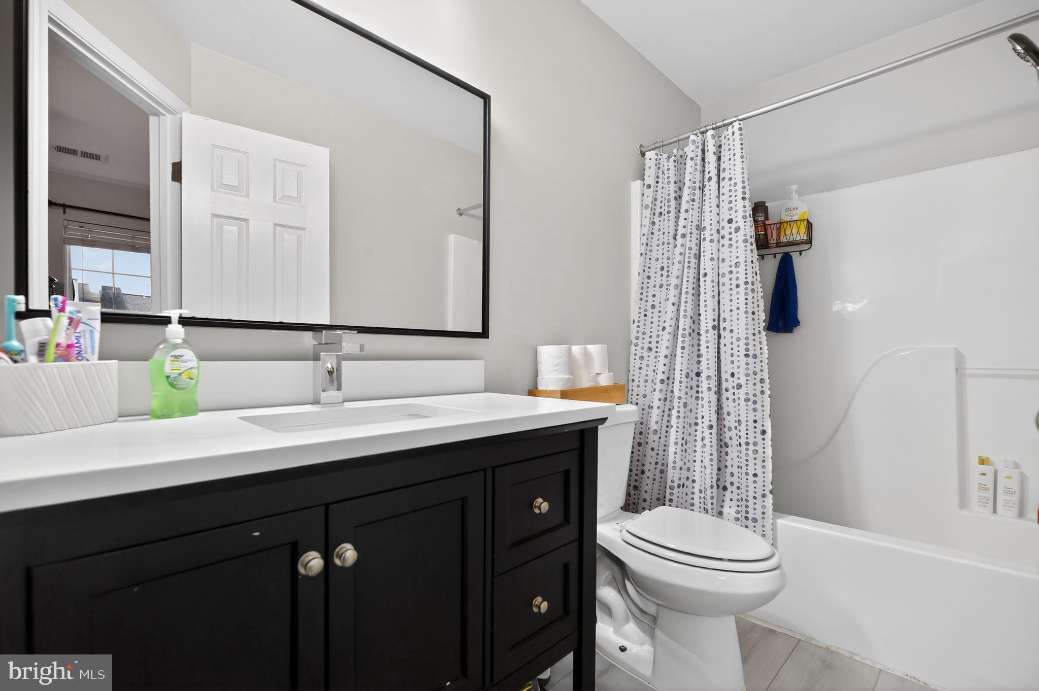 17326 Sligo Loop Dumfries, VA 22026 - Photo 11 of 34 a bathroom with a toilet a sink and mirror