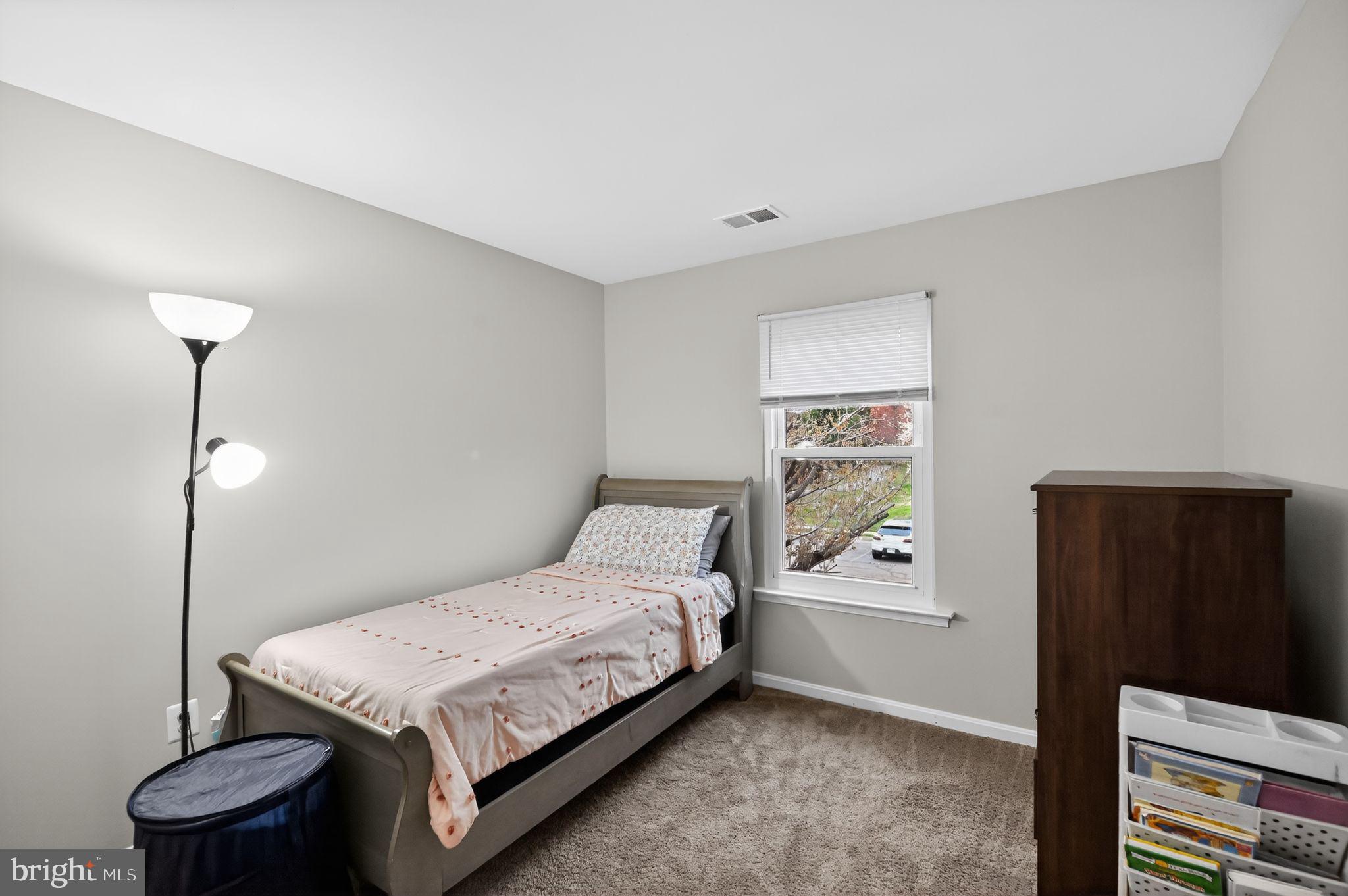 17326 Sligo Loop Dumfries, VA 22026 - Photo 16 of 34 a bedroom with a bed and wooden floor
