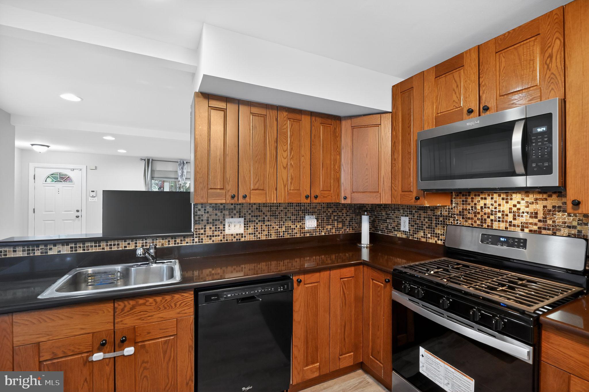 17326 Sligo Loop Dumfries, VA 22026 - Photo 21 of 34 a kitchen with granite countertop a sink stainless steel appliances and cabinets