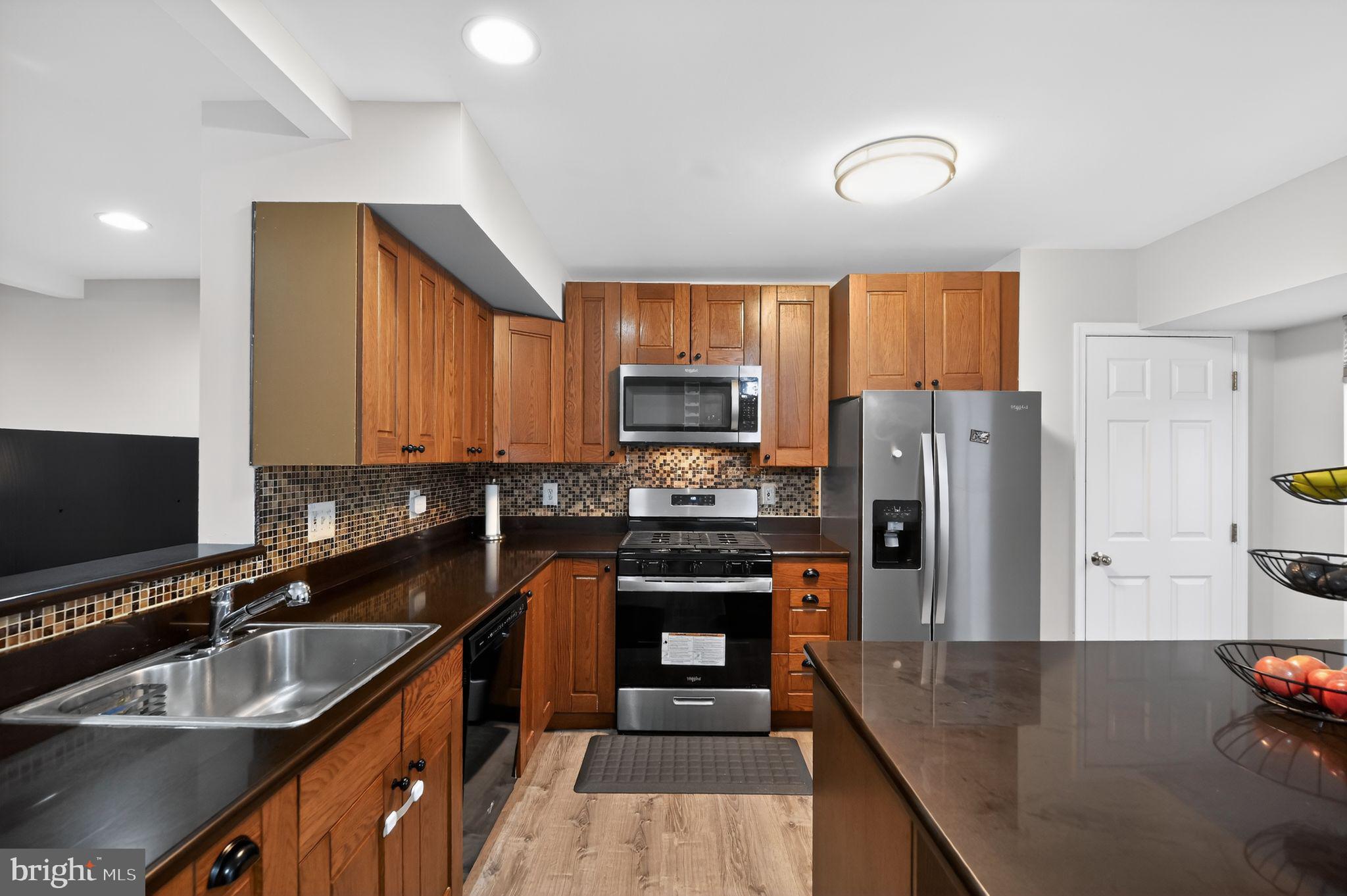 17326 Sligo Loop Dumfries, VA 22026 - Photo 22 of 34 a kitchen with stainless steel appliances a stove refrigerator sink and microwave