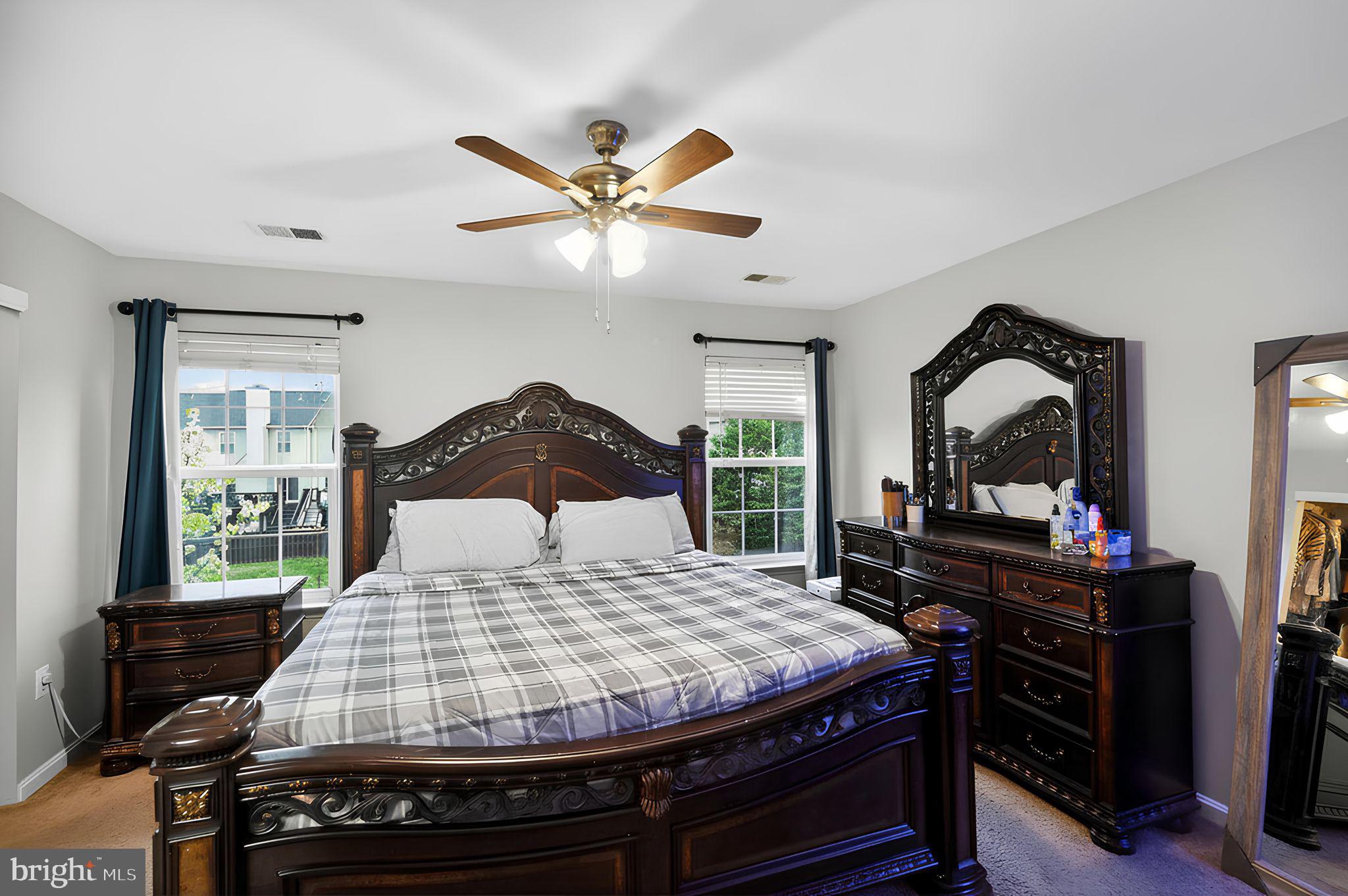 17326 Sligo Loop Dumfries, VA 22026 - Photo 27 of 34 a bedroom with a bed and dresser with mirror