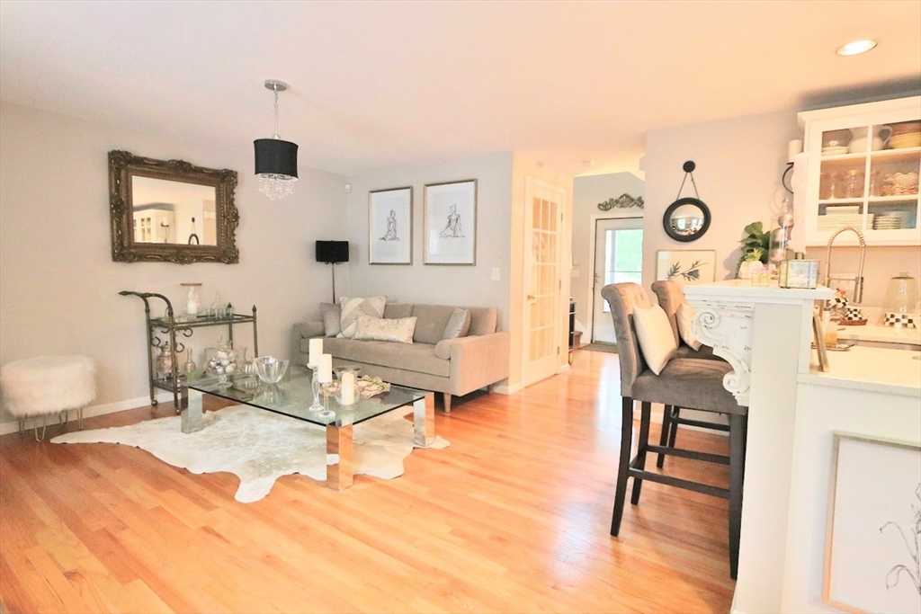 53 Lancaster Road, Unit 7 Clinton, MA 01510 - Photo 11 of 32 a living room with furniture and wooden floor