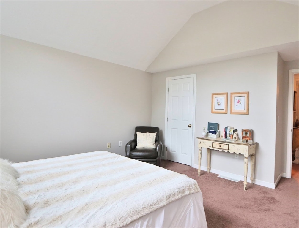 53 Lancaster Road, Unit 7 Clinton, MA 01510 - Photo 14 of 32 a bedroom with a bed and a chair