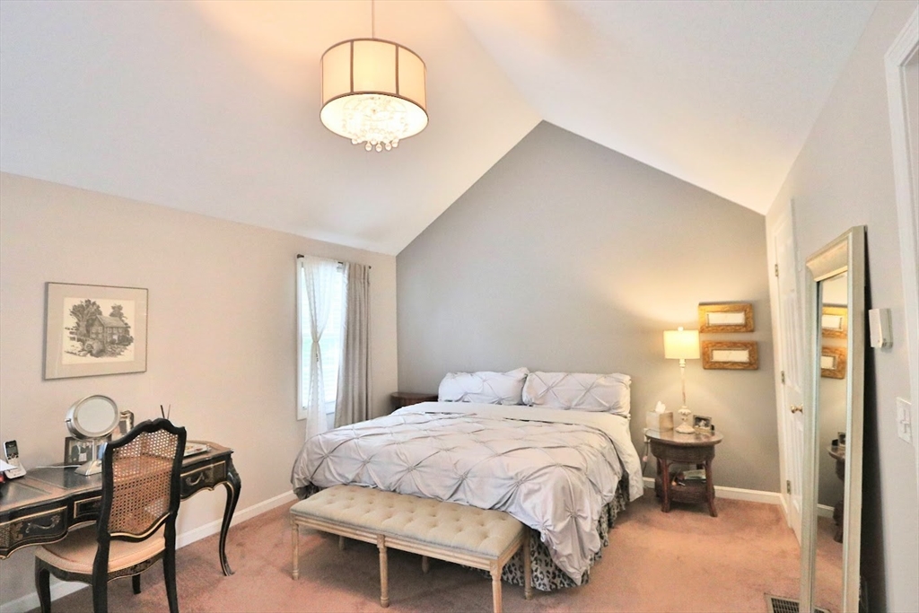 53 Lancaster Road, Unit 7 Clinton, MA 01510 - Photo 17 of 32 a bedroom with a bed and chair