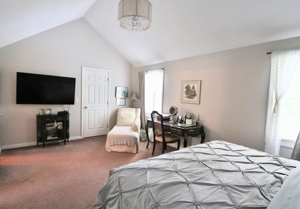 53 Lancaster Road, Unit 7 Clinton, MA 01510 - Photo 19 of 32 a bedroom with a bed and a flat screen tv