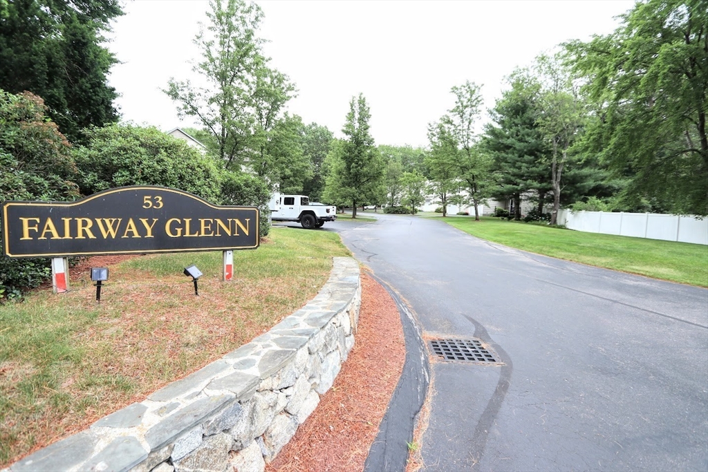 53 Lancaster Road, Unit 7 Clinton, MA 01510 - Photo 2 of 32 a view of a street with a park sign on the side of the road