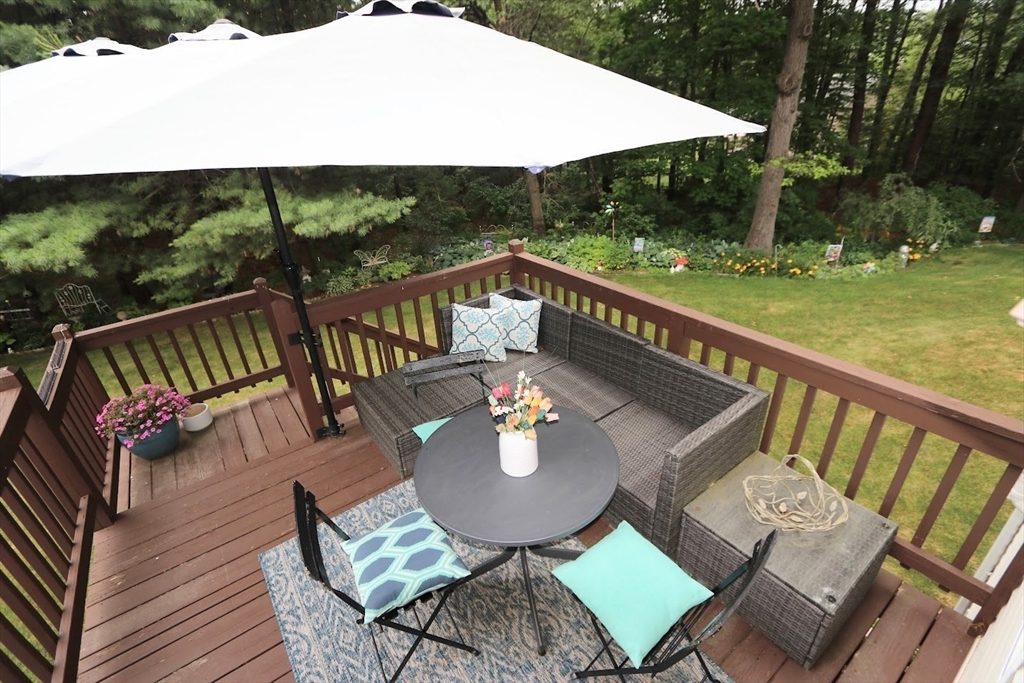 53 Lancaster Road, Unit 7 Clinton, MA 01510 - Photo 23 of 32 a view of a chairs and table on the wooden roof deck