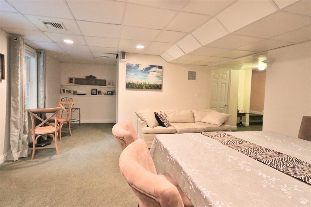 53 Lancaster Road, Unit 7 Clinton, MA 01510 - Photo 25 of 32 a spacious bedroom with a bed a table and chair