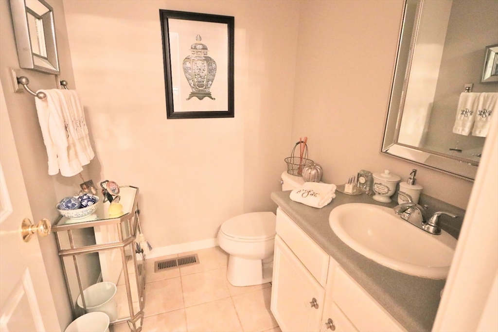 53 Lancaster Road, Unit 7 Clinton, MA 01510 - Photo 30 of 32 a bathroom with a sink vanity mirror and toilet