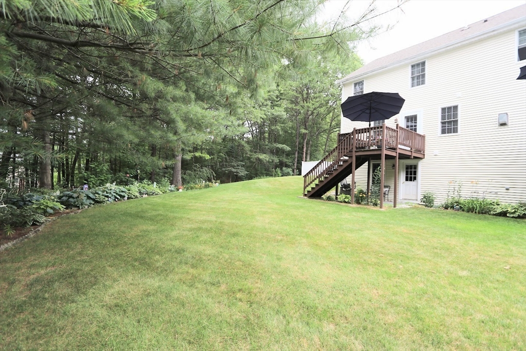 53 Lancaster Road, Unit 7 Clinton, MA 01510 - Photo 3 of 32 a view of a house with backyard and trees