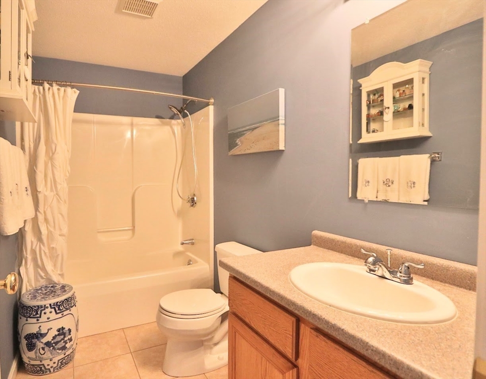 53 Lancaster Road, Unit 7 Clinton, MA 01510 - Photo 31 of 32 a bathroom with a granite countertop sink toilet and shower