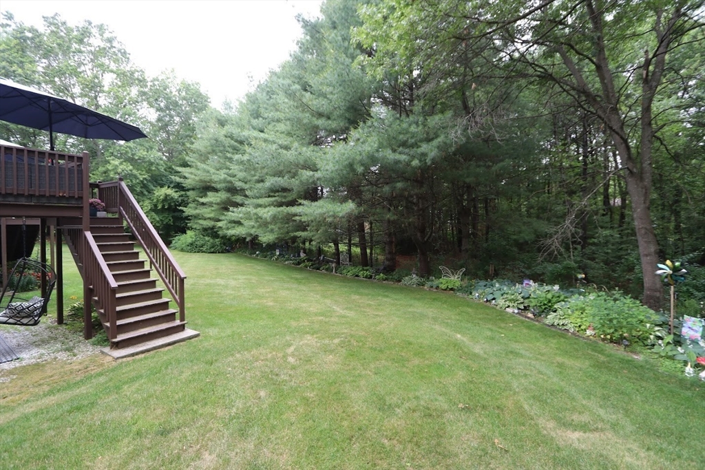53 Lancaster Road, Unit 7 Clinton, MA 01510 - Photo 4 of 32 a view of a backyard with sitting area