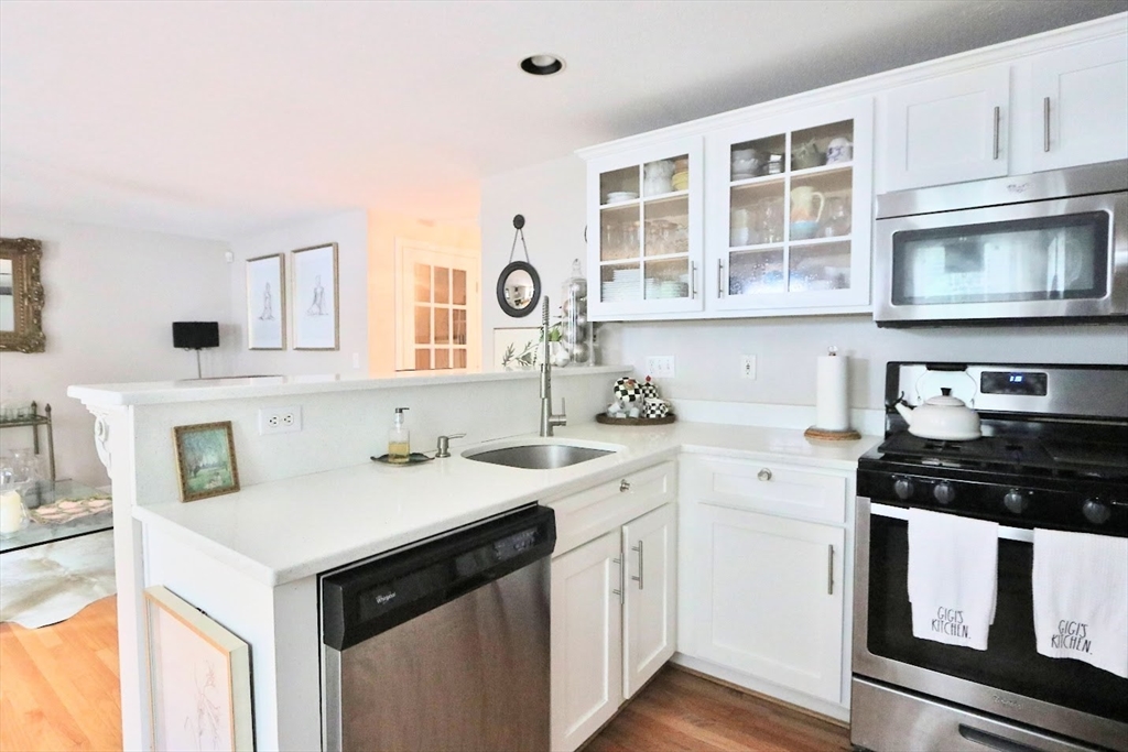 53 Lancaster Road, Unit 7 Clinton, MA 01510 - Photo 8 of 32 a kitchen with stainless steel appliances granite countertop a stove a sink and a microwave