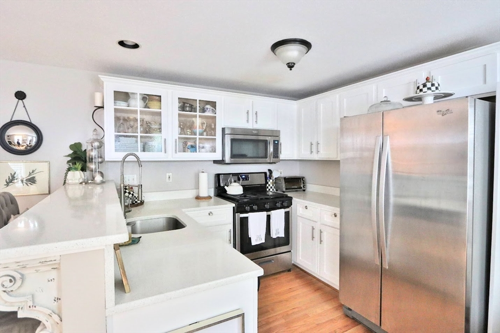 53 Lancaster Road, Unit 7 Clinton, MA 01510 - Photo 9 of 32 a kitchen with granite countertop a refrigerator stove top oven and sink