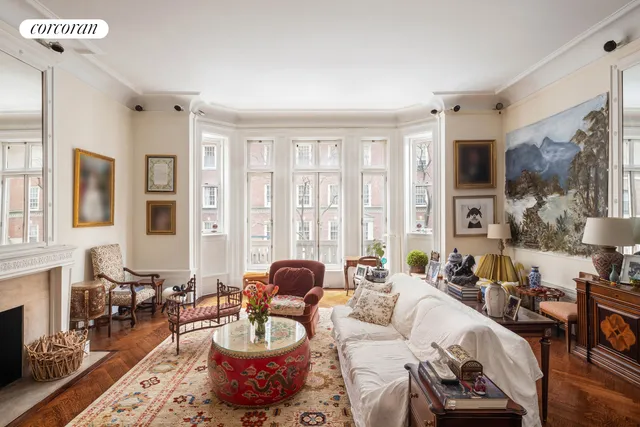 a living room with furniture wooden floor and a large window