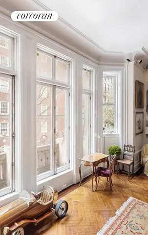 a living room with furniture and a floor to ceiling window