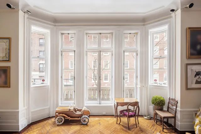 a living room with furniture and a floor to ceiling window