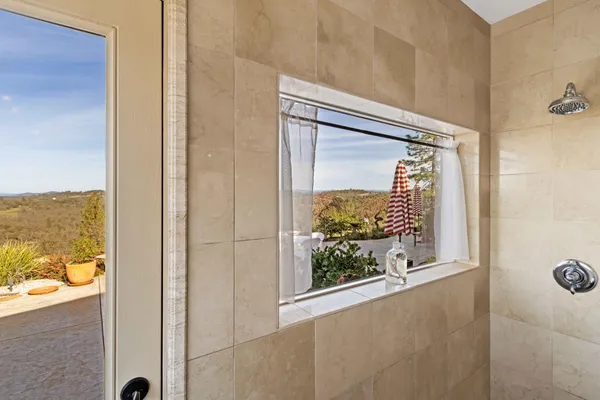 a view of a hallway with window and stairs