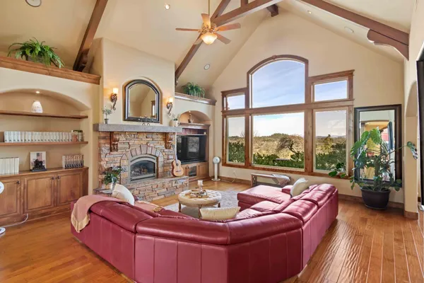 a living room with furniture a fireplace and large window