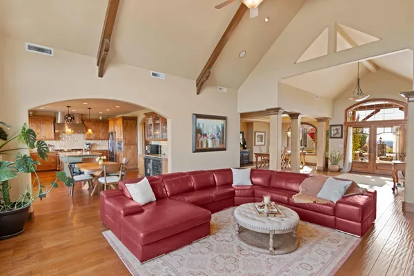 a living room with furniture a fireplace and a floor to ceiling window