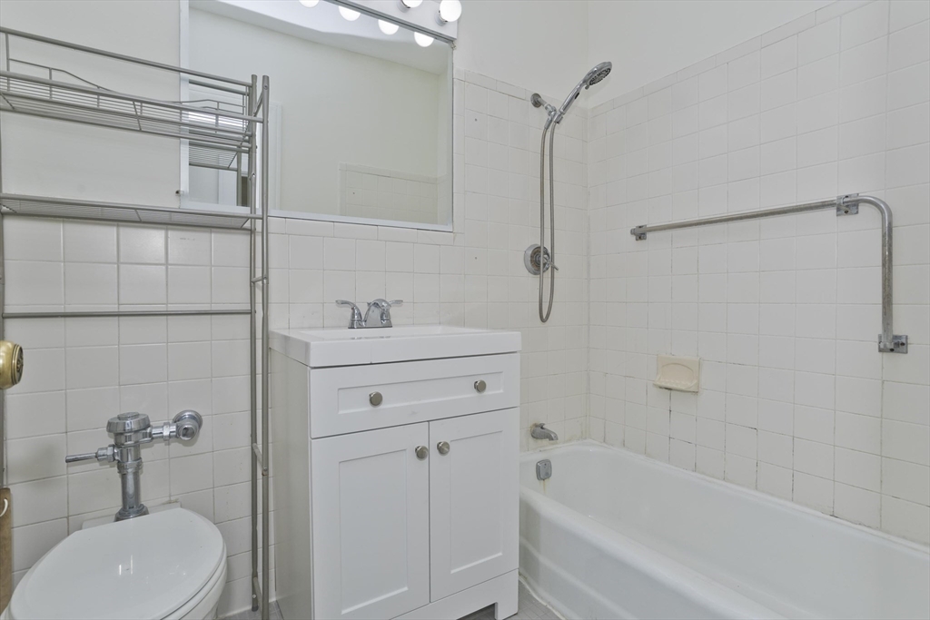 140 Chestnut Street, Unit 404 Springfield, MA 01103 - Photo 12 of 15 a bathroom with a sink toilet and shower