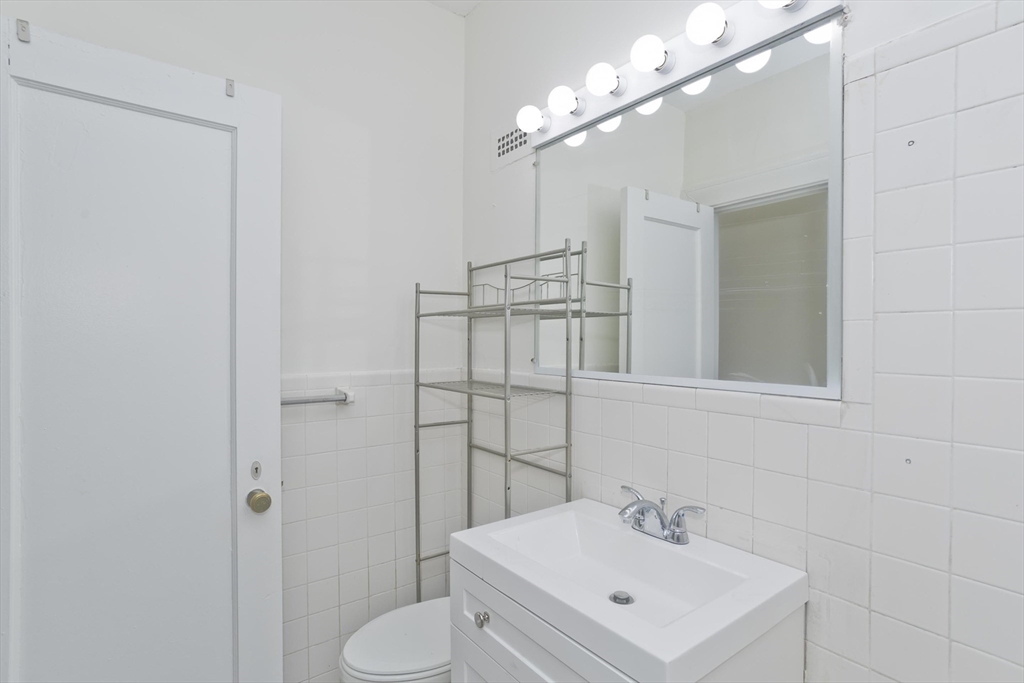 140 Chestnut Street, Unit 404 Springfield, MA 01103 - Photo 13 of 15 a bathroom with a sink toilet and shower