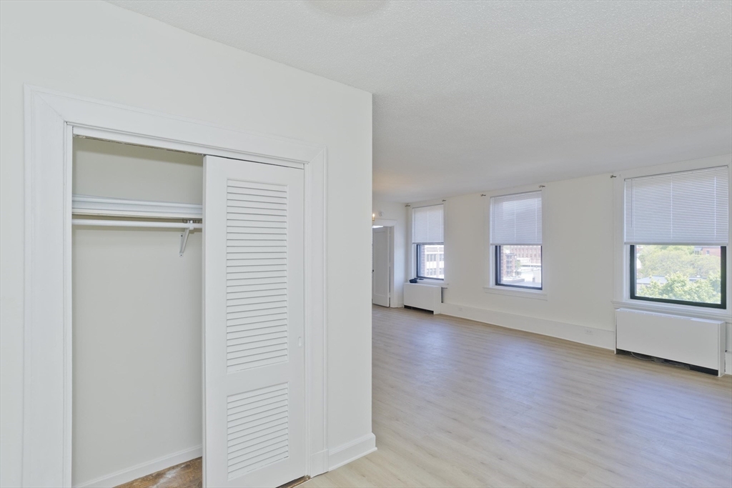 140 Chestnut Street, Unit 404 Springfield, MA 01103 - Photo 7 of 15 a view of an empty room with a window and wooden floor