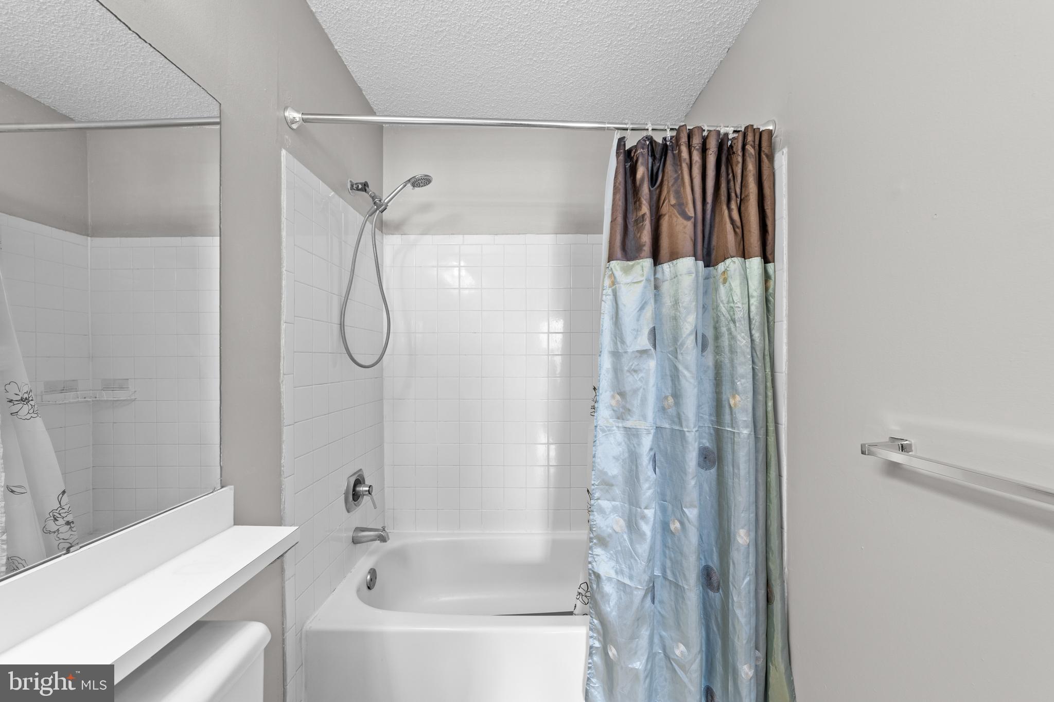 21 Kite Court Lawrenceville, NJ 08648 - Photo 18 of 30 a bathroom with a shower curtain and a bathtub