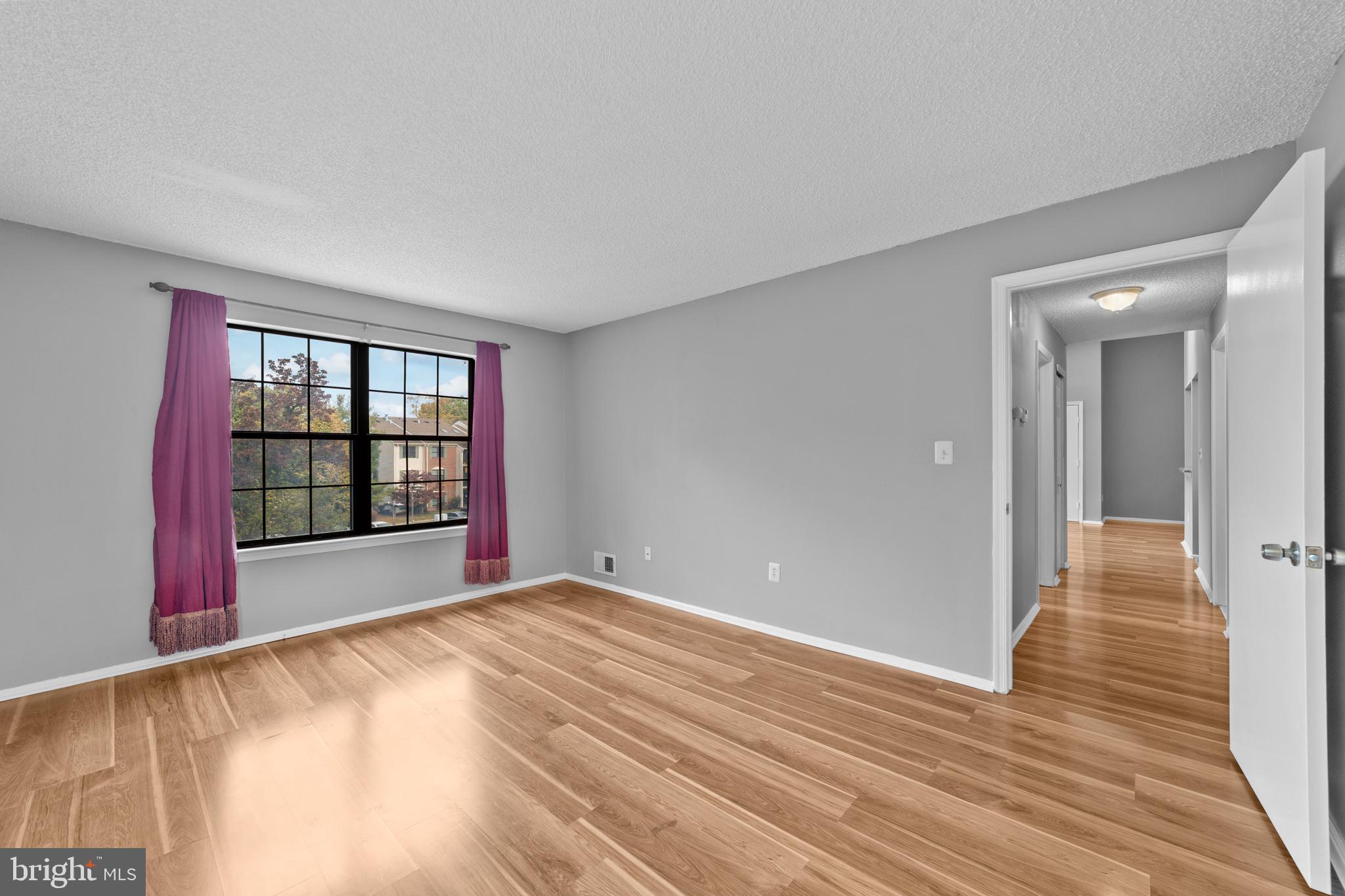 21 Kite Court Lawrenceville, NJ 08648 - Photo 25 of 30 a view of an empty room with window and wooden floor