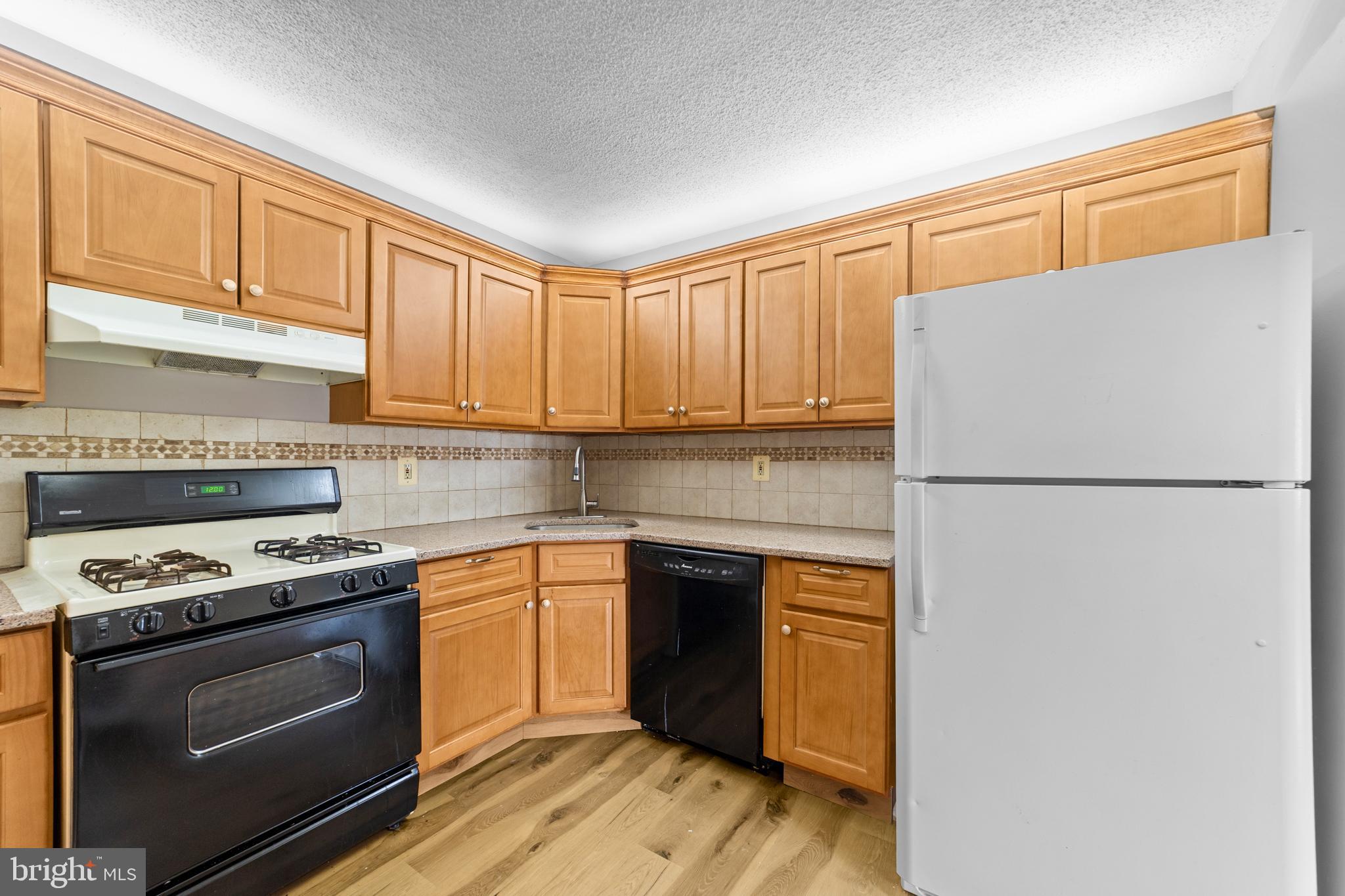 21 Kite Court Lawrenceville, NJ 08648 - Photo 8 of 30 a kitchen with stainless steel appliances granite countertop cabinets and a refrigerator