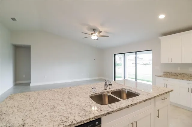 a kitchen with a sink a counter space and cabinets