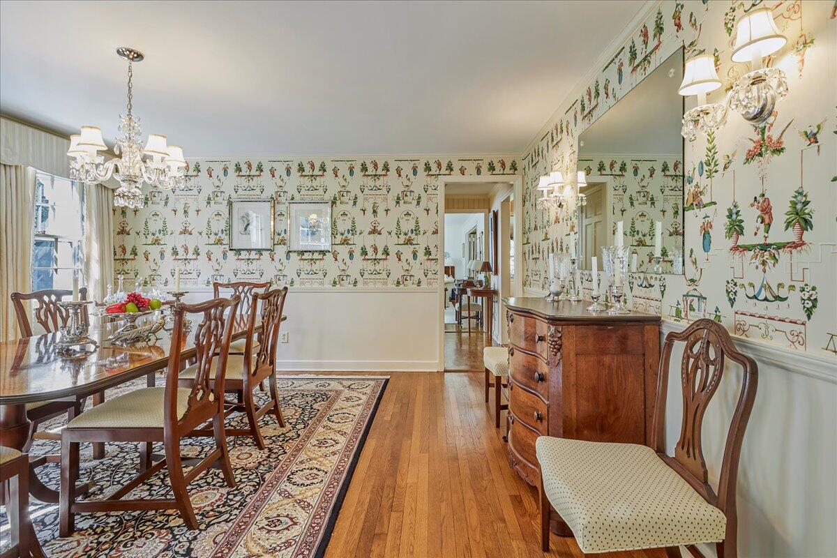 110 Ridge Acres Road Darien, CT 06820 - Photo 11 of 30 a dining room with furniture a chandelier and wooden floor