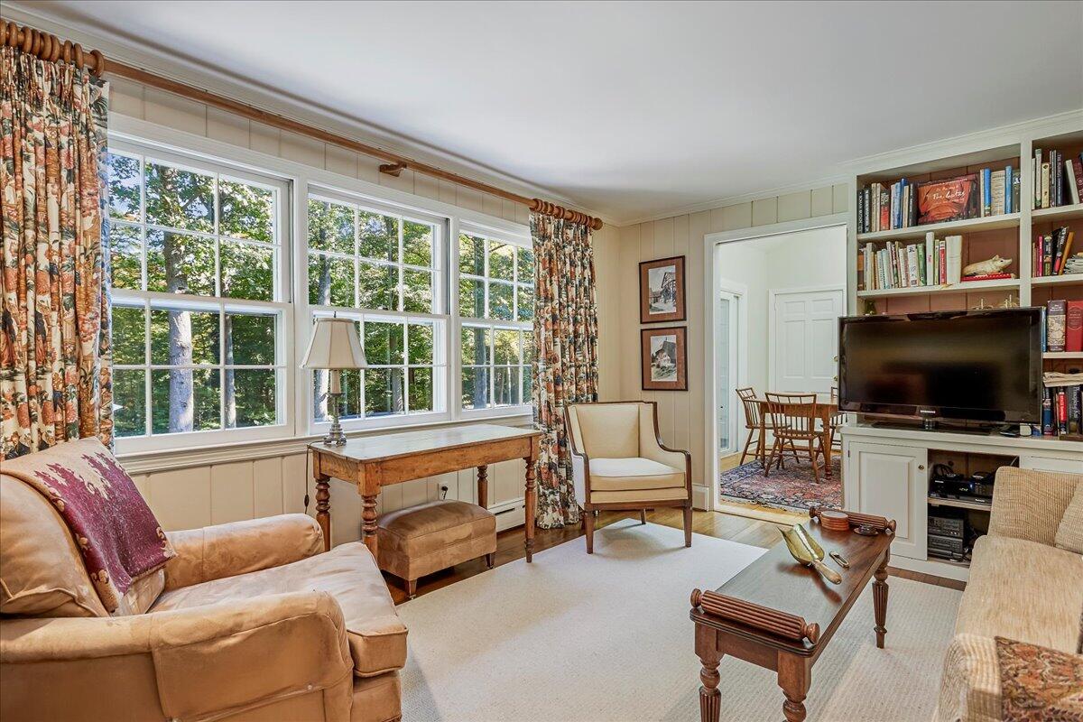 110 Ridge Acres Road Darien, CT 06820 - Photo 15 of 30 a living room with furniture a flat screen tv and a large window