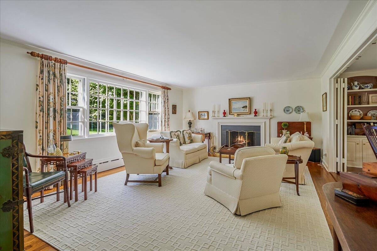 110 Ridge Acres Road Darien, CT 06820 - Photo 6 of 30 a living room with fireplace furniture and a table