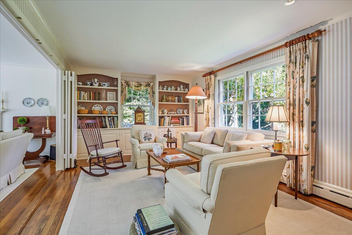 110 Ridge Acres Road Darien, CT 06820 - Photo 10 of 30 a living room with furniture a large window and a book shelf