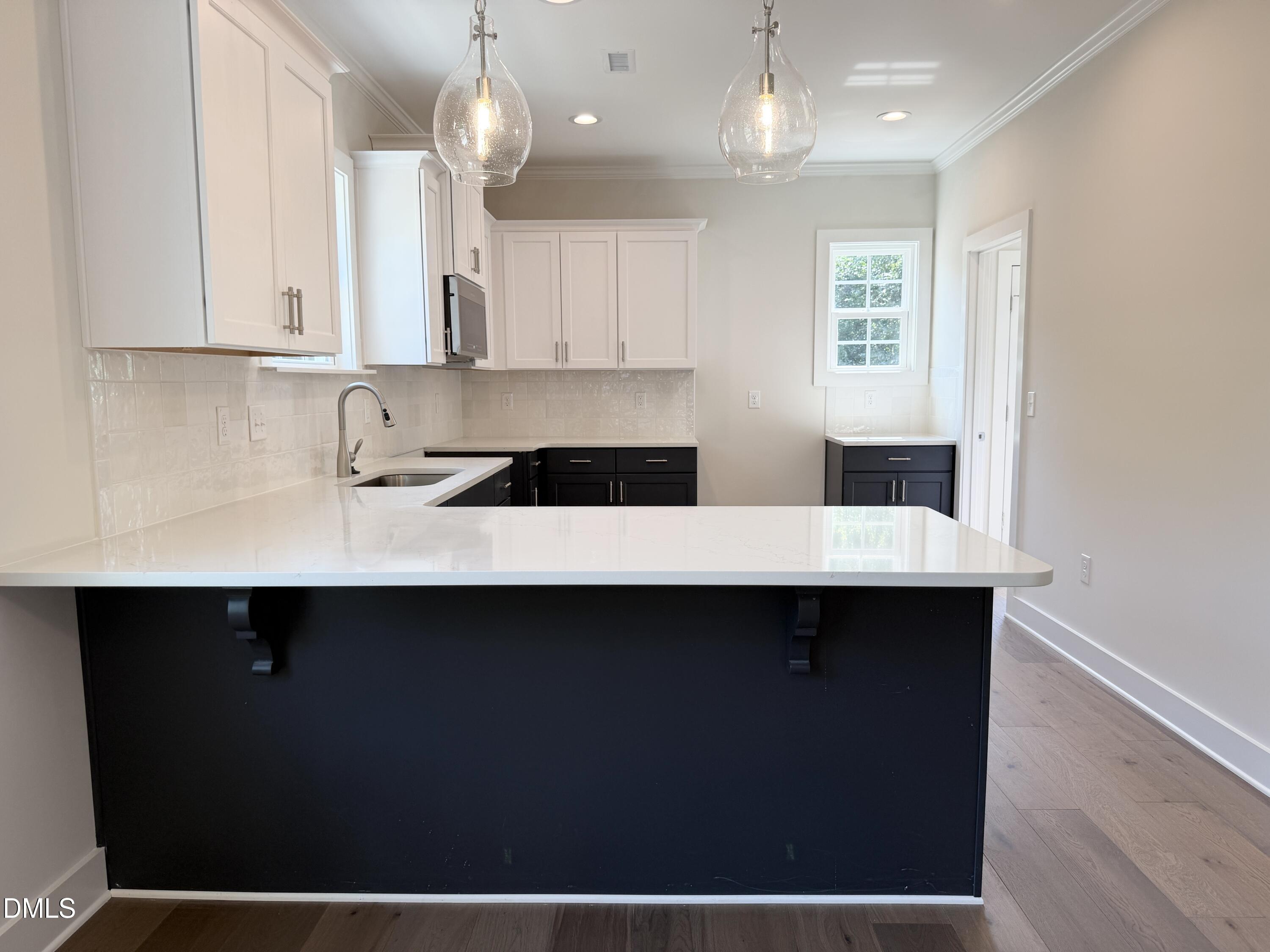 1122 Berkeley Street Durham, NC 27705 - Photo 8 of 29 a kitchen with a sink cabinets and window