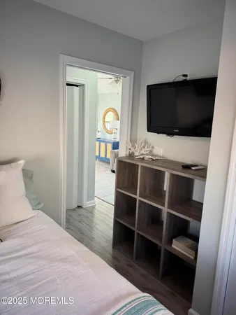 a bedroom with a flat screen tv and a bed