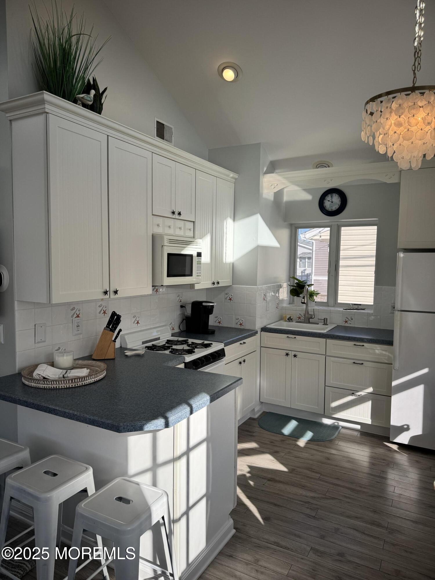 120 West Chadwick Way Lavallette, NJ 08735 - Photo 5 of 13 a kitchen with a stove a sink and a refrigerator