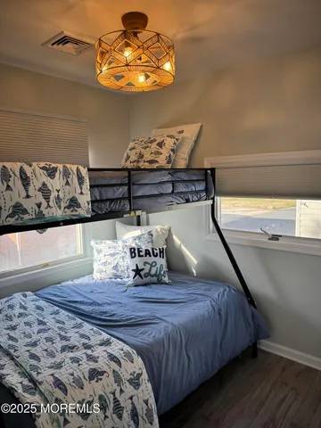 a bedroom with bed and wooden floor