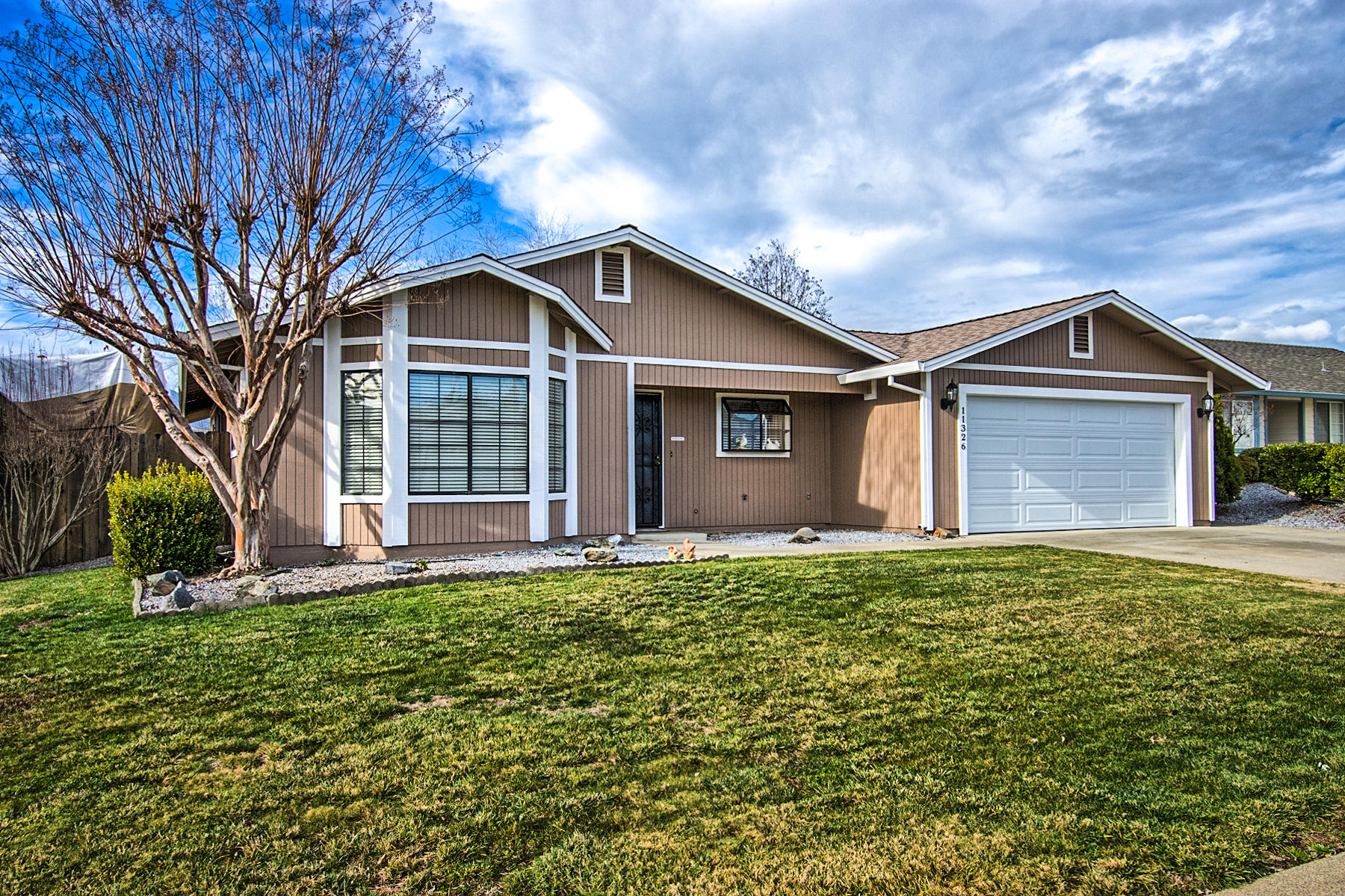 11326 Puffin Way Redding, CA 96003 - Photo 1 of 26 a front view of a house with a garden