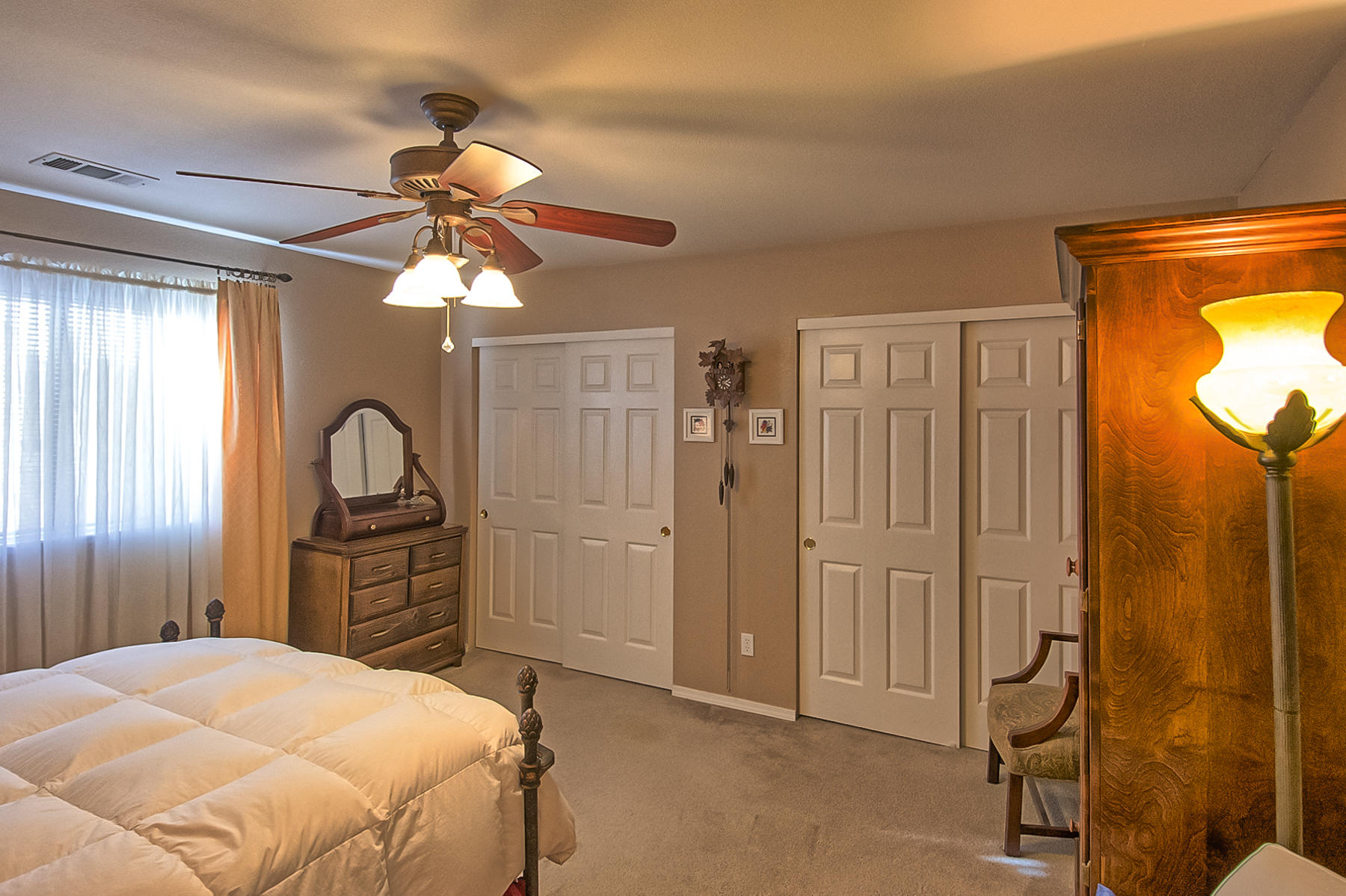 11326 Puffin Way Redding, CA 96003 - Photo 11 of 26 a bedroom with a bed and a chandelier