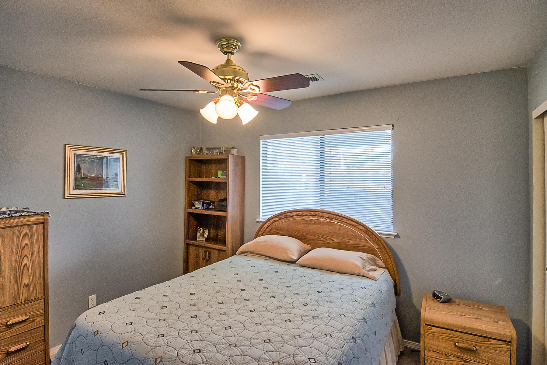11326 Puffin Way Redding, CA 96003 - Photo 17 of 26 a bedroom with a bed and a chandelier