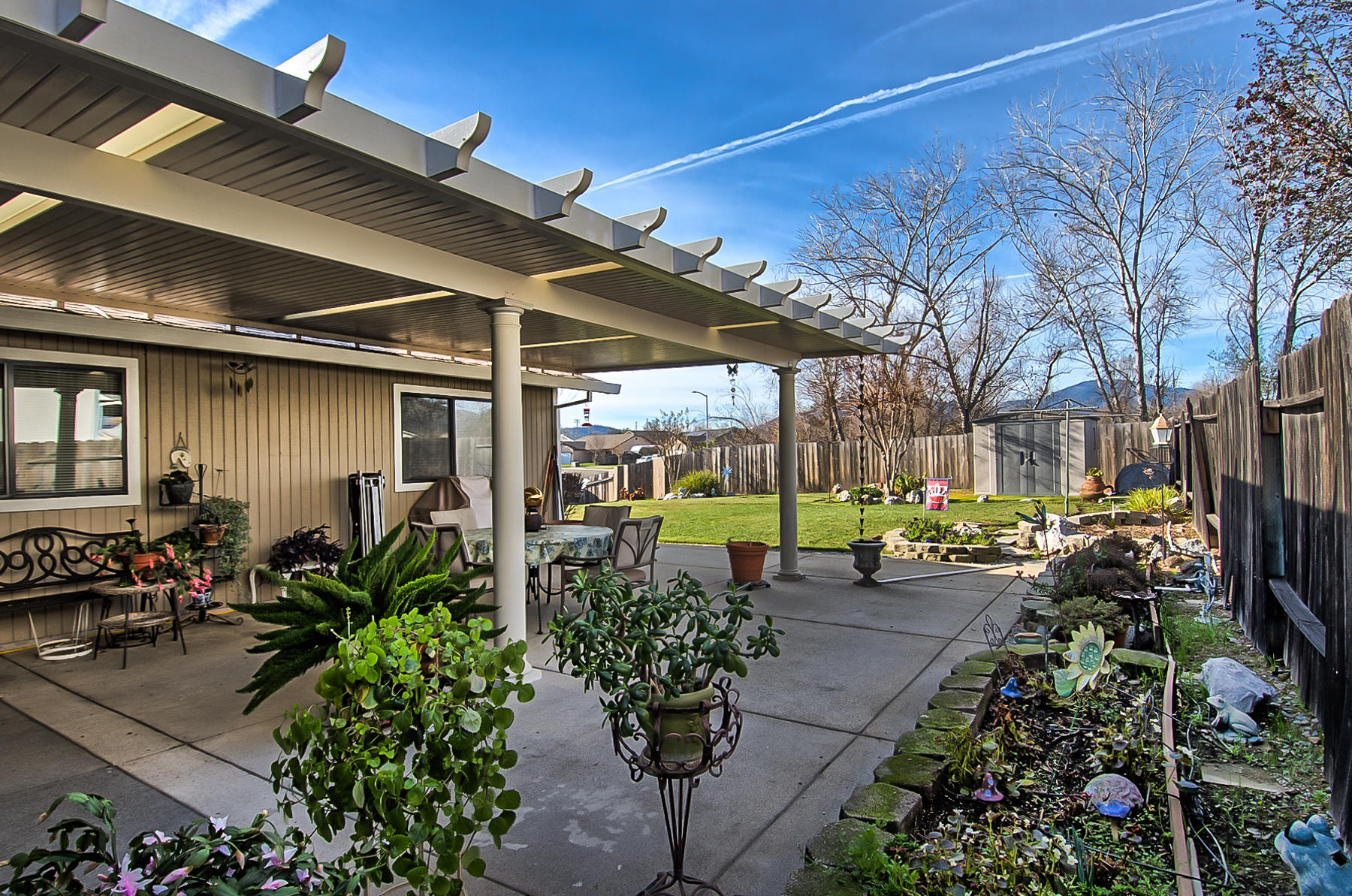 11326 Puffin Way Redding, CA 96003 - Photo 21 of 26 a view of a patio with table and chairs potted plants