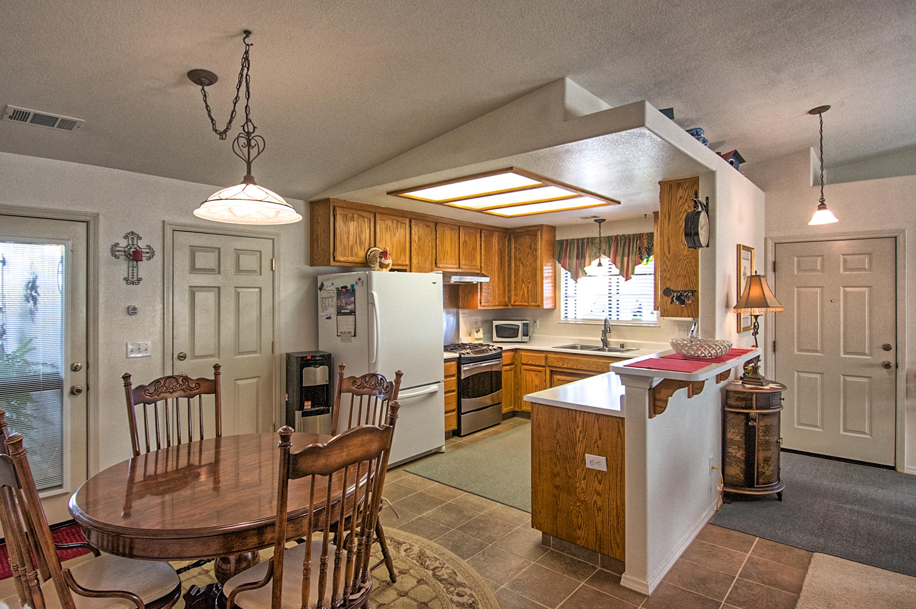 11326 Puffin Way Redding, CA 96003 - Photo 6 of 26 a kitchen that has a table and chairs in it