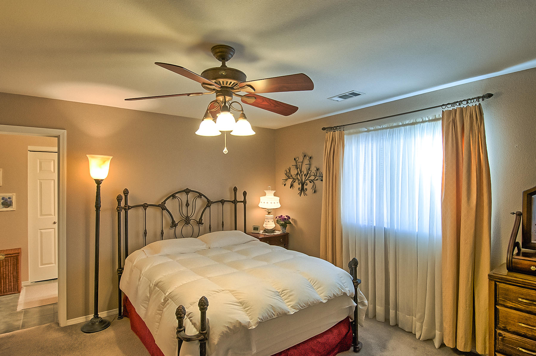 11326 Puffin Way Redding, CA 96003 - Photo 10 of 26 a bedroom with a bed and a chandelier