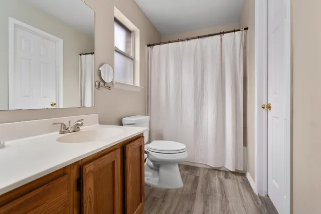 a bathroom with a sink a toilet and a mirror