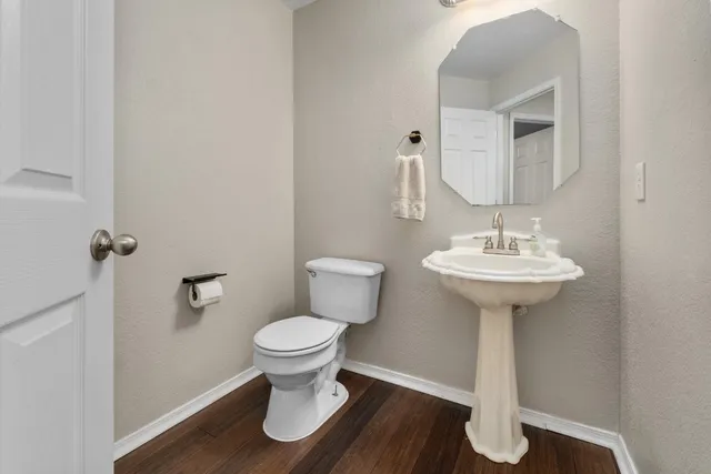 a bathroom with a sink toilet and a mirror