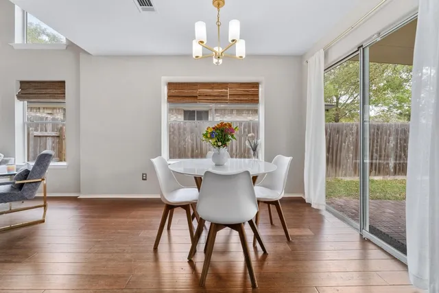 a view of a dining room with furniture wooden floor and chandelier